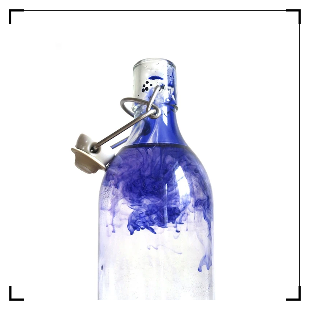 Blue Ink Polluted water in a glass bottle