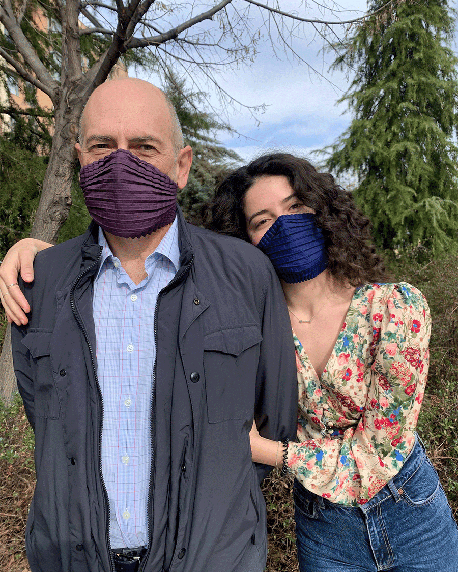 Two people stand outdoors embracing - both wearing Petit Pli MSK. 