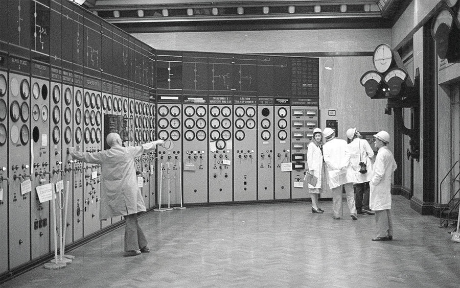 Historic control room at Battersea Power Station with dials and gauges, where engineers in white coats once managed the iconic London landmark.