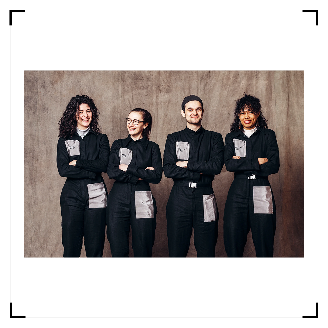 Photo of the Petit Pli Team - smiling, crossed arms, dressed in custom uniforms