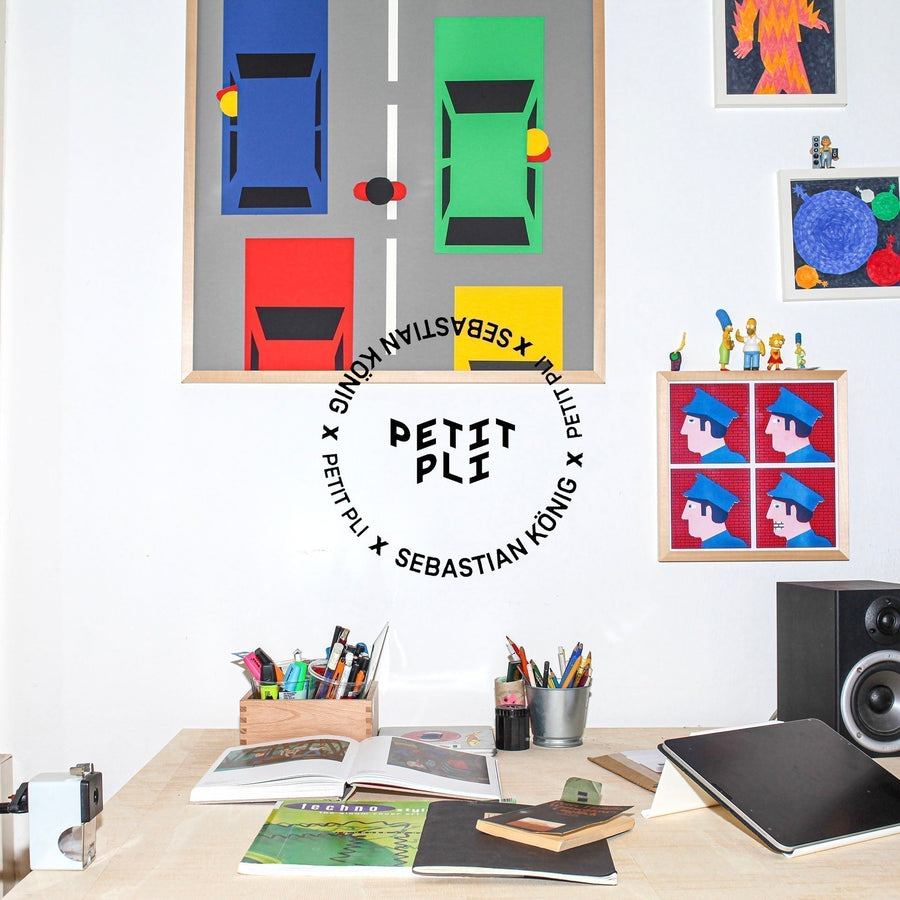 Sebastians Desk overlooked by posters of his characters are a whimsical designs, playfully creative