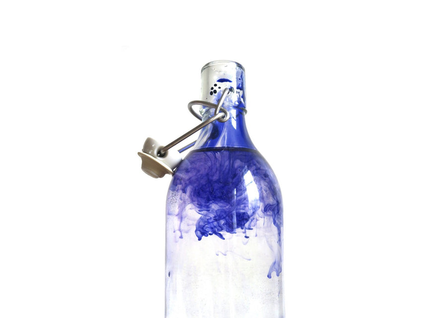 Glass bottle of water Polluted with Ink