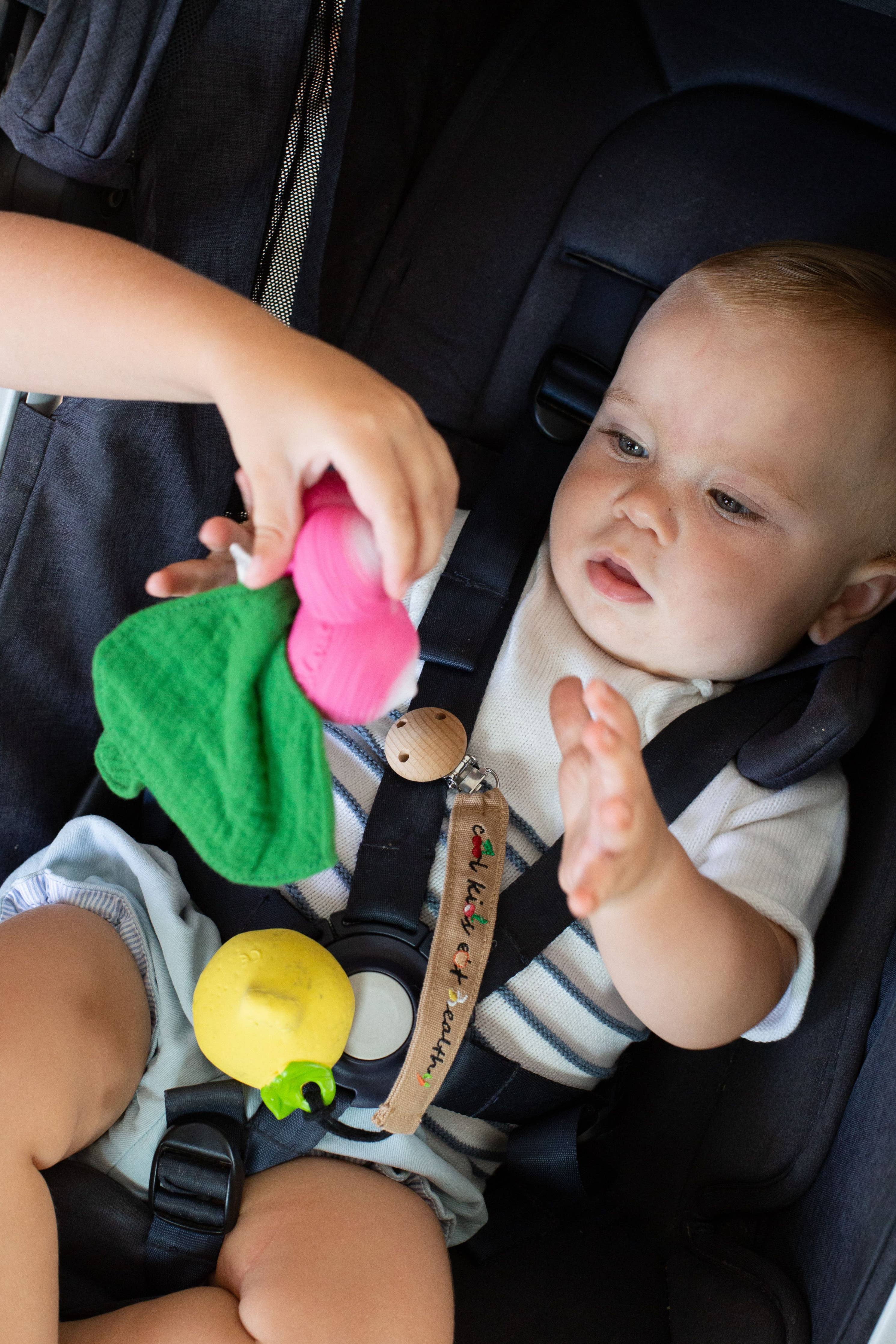 Baby using Oli&Carol Cool Kids pacifier clip